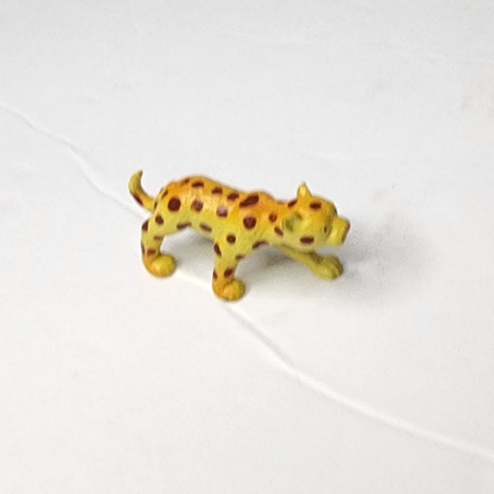 Yellow leopard shaped toy made of plastic